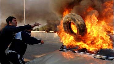 protesters burn car 