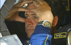NASCAR driver Michael Waltrip waits in his car before the start of practice 
