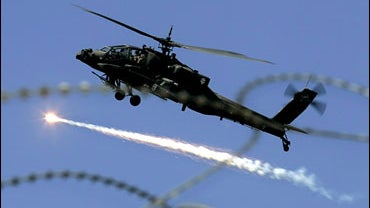 A U.S. military Apache helicopter releases an anti missile decoy flair as it files over Baghdad, Iraq, Thursday, Feb. 15, 2007. 