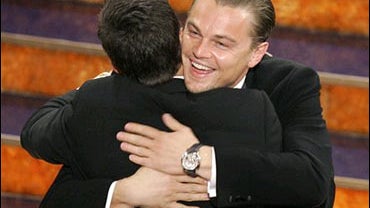 Leonardo DiCaprio, right, hugs Mark Wahlberg 