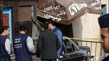 Police officers investigate after an explosion occurred in an Internet cafe in Sidi Moumen 