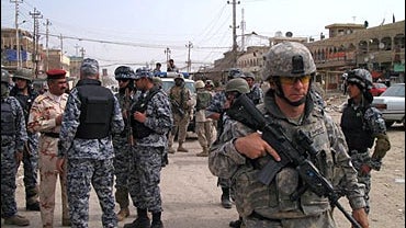 A US soldier keeps watch in a Shiite enclave of Sadr City in Baghdad, Iraq, Thursday, March 15, 2007. 