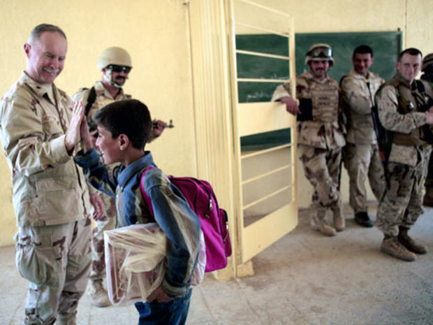Chaplain Steven Thompson from Jacksonville, Fla., with the 125th Fighter Wing, says goodbye to a student at a primary school in Zatiya, 25 miles (40 kilometers) east of Baghdad, Iraq, Wednesday April 18, 2007. 