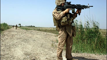 Marine Lance Corporal Larry Martin from Odessa, Texas of Mobile Assault Platton 3 of Weapons Company 2 Battalion, 7th Marines uses the scope on his weapon to scan in the distance during a security patrol May 14, 2007 in the area known as Zaidon in the Al  
