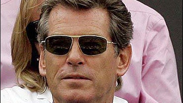 Pierce Brosnan watches Andy Roddick of the United States against Britain's Alex Bogdanovic 