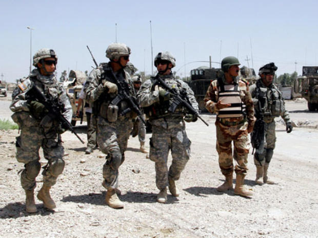 Iraqi and US troops walk the streets of Baqouba, 60 kilometers (35 miles) northeast of Baghdad, Monday, June 25, 2007. 