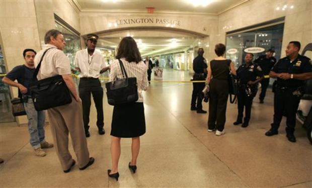 New York city police officers block the Lexington Ave passage as a Metro North conductor gives morning commuters directions on how to exit Grand Central Station Thursday, July 19, 2007 in New York. 