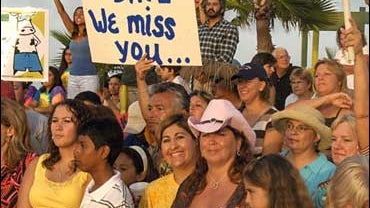 The crowd cheers for Dave Price, who was unable to make it to the "Great American Vacation" giveaway at South Padre Island, Texas, Aug. 1, 2007. 