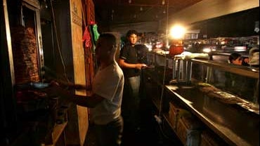 Palestinians use a propane light at their resaurant after the electricity was cut in the area of Gaza City, Sunday, Aug. 19, 2007. 
