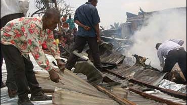 Volunteers search for survivors among the remains of homes, at the site of a cargo plane crash in Kinshasa, Congo, Thursday, Oct. 4, 2007. 