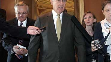 Sen. Larry Craig, R-Idaho, is questioned by reporters after a vote, Tuesday, Sept. 18, 2007, on Capitol Hill in Washington. Craig vowed Thursday, Oct. 4, 2007, to serve out the last 15 months of his term, despite a court ruling that left intact his guilty 