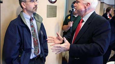 Republican presidential hopeful Sen. John McCain, R-Ariz., talks with Dr. Guy McCaw, left, during stop at the Grinnell Medical Center, Wednesday, Oct. 10, 2007, in Grinnell, Iowa. 