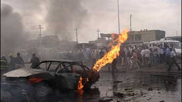 Firefighters try to extinguish the flames after a suicide car bomb struck a busy market in Kirkuk, 180 miles north of Baghdad, Iraq, on Thursday, Oct. 11, 2007. 