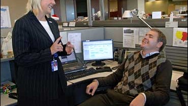 Army National Guardsman John Flor, Allianz manager Amy Gunderson 