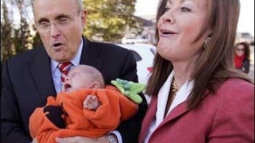 Republican presidential hopeful, former New York Mayor Rudy Giuliani and his wife Judith, react as 3-month old Dahlia Garnick of Amhurst, N.H., starts crying in his arms during a campaign stop at Lull Farm in Hollis, N.H., Sunday, Oct. 28, 2007. (AP Photo 