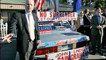 Republican presidential hopeful Sen. John McCain, R-Ariz., talks to supporters as he stands by a supporters' car outside The Hot Dog Heaven Saturday, Nov. 3, 2007, in Irmo, S.C. (AP Photo/Mary Ann Chastain) 