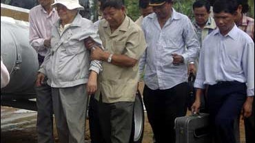 Khieu Samphan, second from left, the former Khmer Rouge head of state, is led to a helicopter in Pailin, Cambodia, Wednesday, Nov. 14, 2007. 