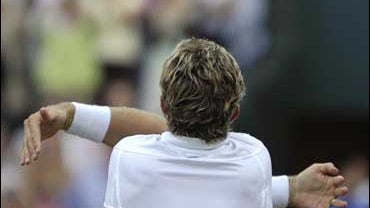 Jonas Bjorkman of Sweden hugs himself after defeating Radek Stepanek during Wimbledon quarterfinals 