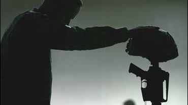 A U.S. army soldier pays his last respect to his fallen comrade, Sgt. Blair W. Emery 