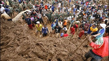 Rescuers search for victims at a village hit by landslides in Tawangmangu, Central Java, Indonesia 