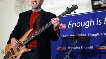 Mike Huckabee on bass guitar 