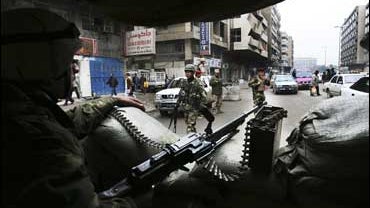 Iraqi Army soldiers man a checkpoint in the center of Baghdad 