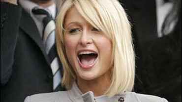 Paris Hilton displays the Harvard Lampoon Woman of the Year Award 