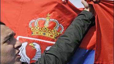 A Kosovar Serb man holds the Serbian flag protesting against Kosovo's independence 