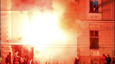The U.S. embassy in Belgrade burns after masked attackers broke into the building 