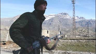 A Turkish soldier patrols to secure a main road in Senoba, Sirnak, at the border with Iraq 