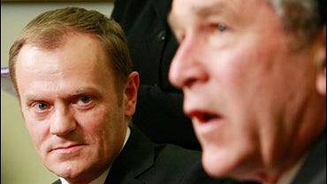 Poland's Prime Minister Donald Tusk, left, looks on as President Bush makes a statement to reporters 