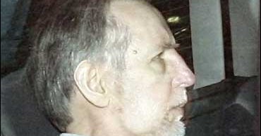 An aerial view of waves crashing against a shore.