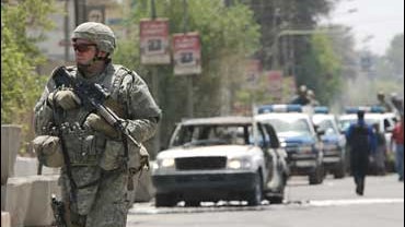 A U.S. Army soldier secures the site where a bomb targeted a motorcade carrying Iraq's first lady as it moved through central Baghdad 