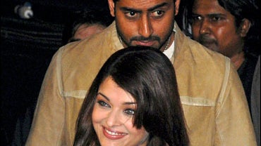Bollywood couple Aishwarya Rai, front, and Abhishek Bachchan arrive for a promotional event of their film "Sarkar Raaj" in Hyderabad, India, Sunday, June 15, 2008. (AP Photo/Mahesh Kumar A.) 