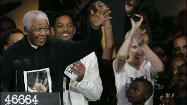 Nelson Mandela, left, speaks as from left U.S. actor Will Smith, British singer Annie Lennox, British Formula 1 driver Lewis Hamilton look on at the 46664 charity concert in honour of his 90th birthday in London, Friday, June 27, 2008, The former South Af 