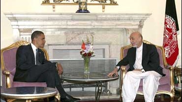 Sen. Barack Obama, left, talks with Afghan President Hamid Karzai, right, at the Presidential Palace in Kabul 