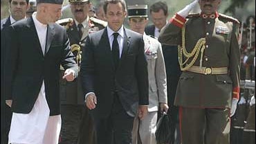 Afghan President Hamid Karzai walks with French President Nicolas Sarkozy 