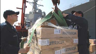 Humanitarian aid supplies are loaded aboard the guided-missile destroyer USS McFaul 