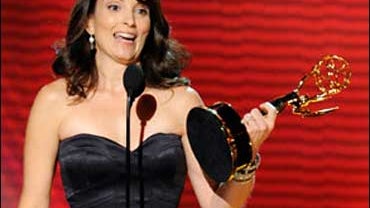Writer, producer and star Tina Fey accepts the award for outstanding writing for a comedy series for her work on the "30 Rock" episode titled "Cooter" at the 60th Primetime Emmy Awards Sunday, Sept. 21, 2008, in Los Angeles. 