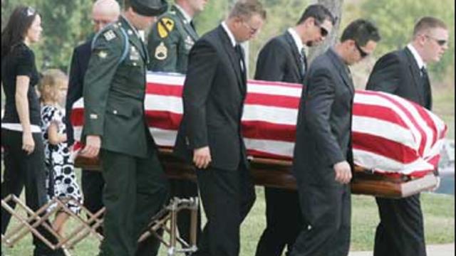 Soldiers carry the flag-draped casket of Michael Thompson after his funeral service in Kingston, Okla. 