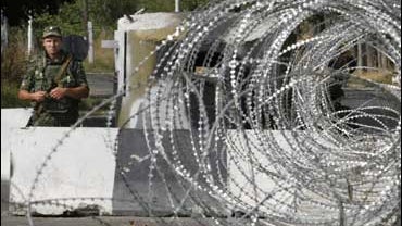 A Russian soldier stands at a checkpoint at the village of Karaleti, Georgia 
