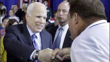 Republican presidential candidate, Sen. John McCain, R-Ariz., shakes hands with a supporter at a rally at Cape Fear Community College in Wilmington, N.C. on Oct. 13, 2008. 