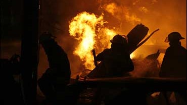 Firefighters try to douse the flames after a small aircraft crashed during rush hour in Mexico City on Nov. 4, 2008. Authorities have confirmed that Mexico's top anti-drug prosecutor, Jose Luis Santiago Vasconcelos and Mexico's Interior Secretary, equival 