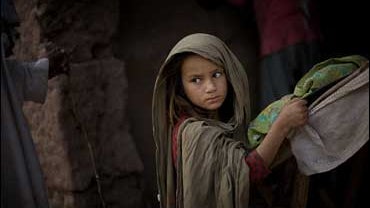A Pakistani girl from the Bajur tribal region waits to buy bread next to the Katcha Garhi camp in Peshawar, Pakistan on Nov. 6, 2008. 
