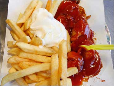 n this Jan. 15, 2008 file photo, a plate with Currywurst and French Fries is seen in a fast food restaurant in Berlin. Berliners love their sliced sausage smothered in a curried ketchup sauce, preferably with fries. Available anywhere in town. (AP Photo/M