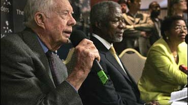 Former U.S. president Jimmy Carter, left, former U.N. secretary-general Kofi Annan, center, and rights advocate Graca Machel 
