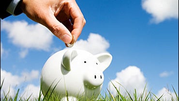 Businessman loading a piggy bank 