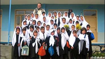 Greg Mortenson stands with schoolgirls from the Lalander village school in Afghanistan 