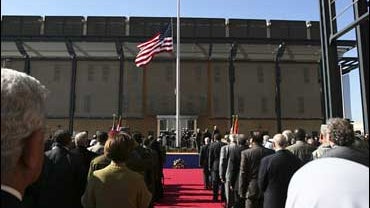 People watch the U.S. flag as it is raised during a ceremony marking the opening of the new U.S. Embassy in Baghdad 