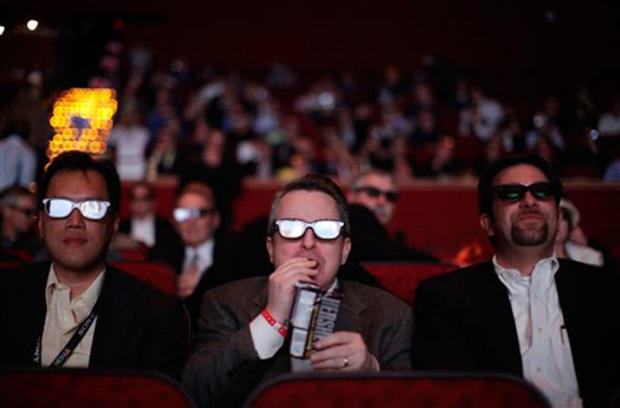 Audience members wear special glasses as they watch a live 3D broadcast of the BCS Championship NCAA college football game between Florida and Oklahoma at the International Consumer Electronics Show (CES) in Las Vegas, Thursday, Jan. 8, 2009. 